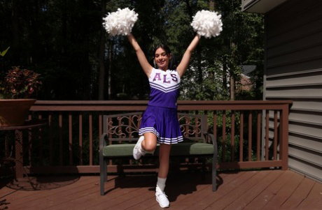 Brunette cheerleader Aria Valencia discards her uniform before masturbating