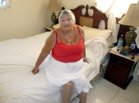 Fat old woman Grandma Libby bares her tan lined tits and twat on her bed