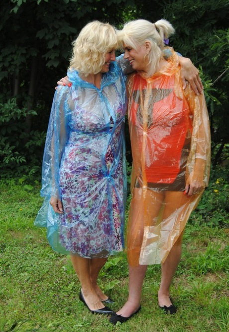 Mature lesbian Dimonty and GF cover their naked bodies in see thru raincoats