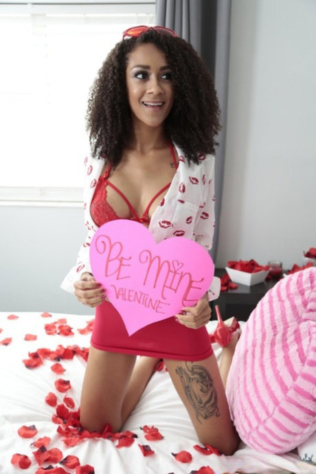 Curly haired ebony Ariana Aimes flaunts her big tits while riding a dick