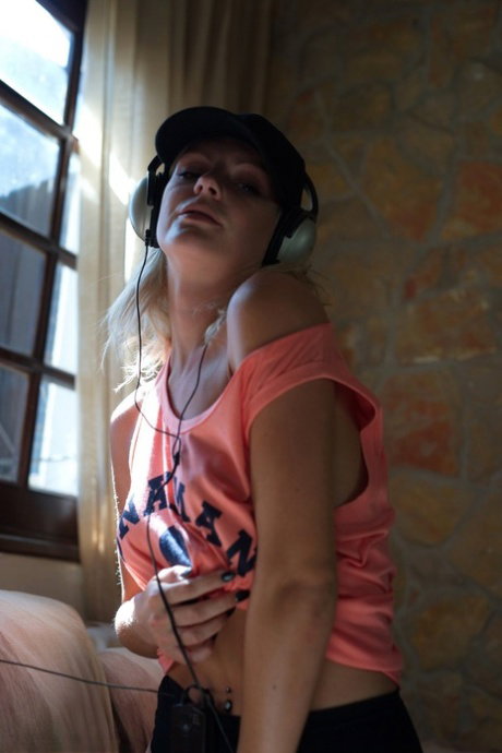 Hot blonde Victoriah gets naked while listening to music on her headphones