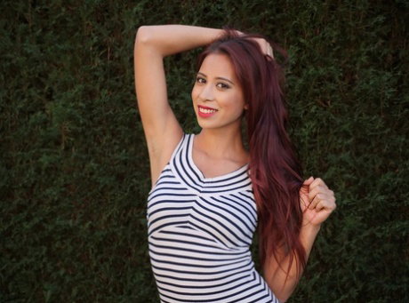 Solo girl Paula Shy bares her tits on a lawn in hose over panties and nylons