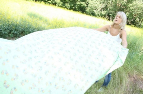 Delicious babe Caroline D fingering her bald pussy to orgasm in nature