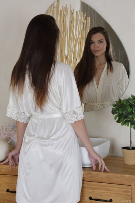 Blue eyed teen Adriana Fawn drops her robe and fingers her pussy