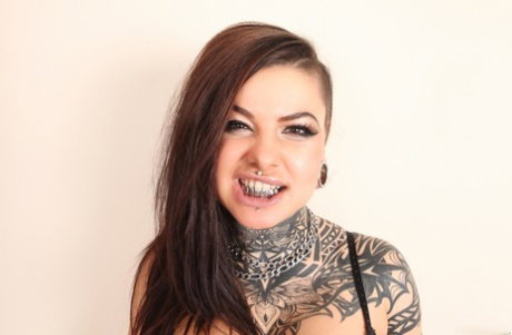 Tattooed alt model spreads her legs wearing black hookers socks and heels