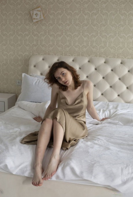Barely legal girl Levia cupped her great tits while going nude on a bed