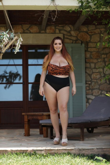 Redheaded fatty Lucy Vixen strips her top and shows her huge natural tits