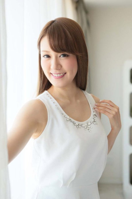 Japanese honey Ruri Tachibana strips and takes two big knobs on a bed