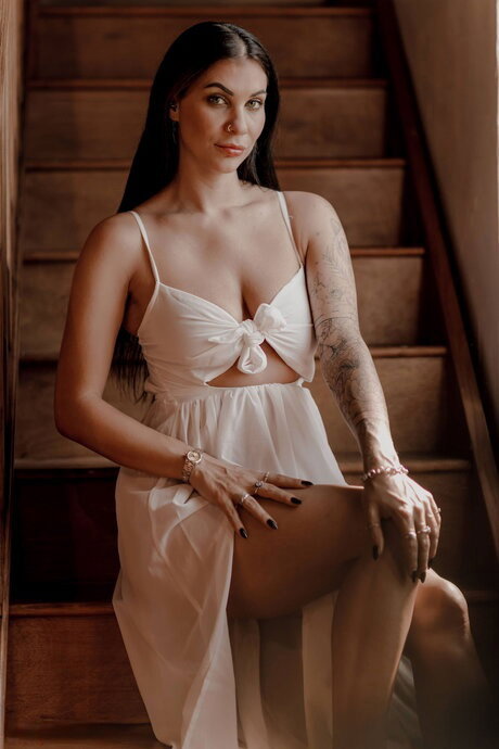 Brunette chick Roxy Mendez unveils her big tits on a set of stairs