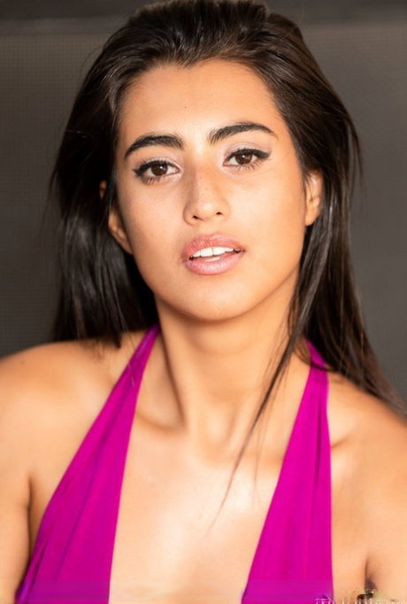 Latina teen Katherinne removes a long pink dress to model in the nude