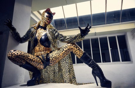 Solo model strikes hot poses in full body leopard print costume