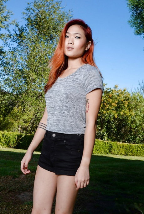 Redheaded Asian amateur Lea Hart exposing nice ass and pussy outdoors