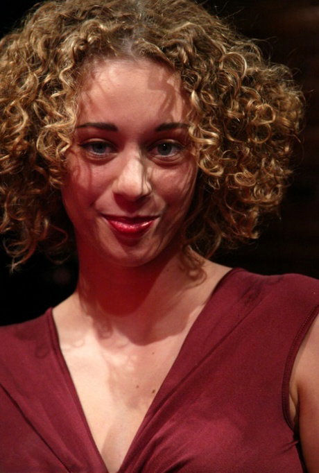 Curly-haired American Lola strips and fucks a machine dildo in a solo