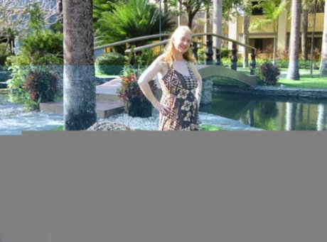 Older UK amateur Lily May sets her large boobs loose while walking on a beach
