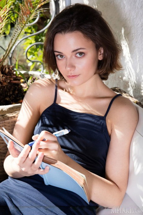 Petite teen Kertu scribbles in her diary before getting totally naked