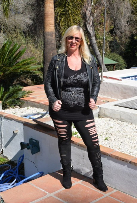 Older blonde fatty Melody exposes her big thong covered butt while outdoors