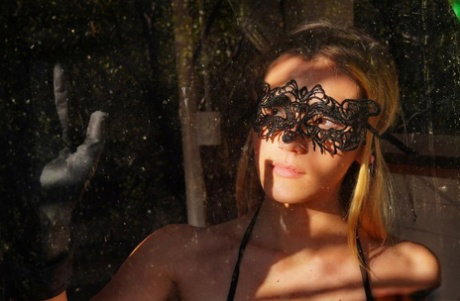 Sexy teen Stefany takes off a masquerade mask in a revealing bodystocking