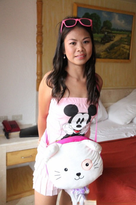 Petite Asian first timer removes Mickey Mouse top on way to getting naked