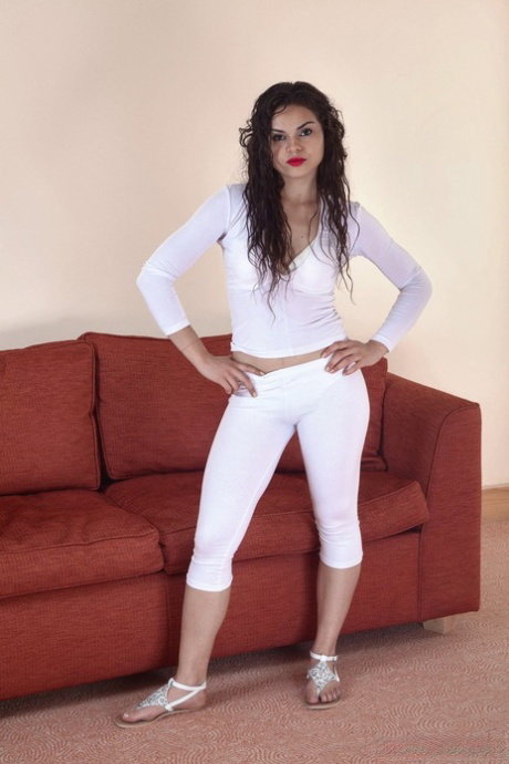 MILF in a white jumpsuit Sierra strips & shows hairy pussy & armpits on a sofa