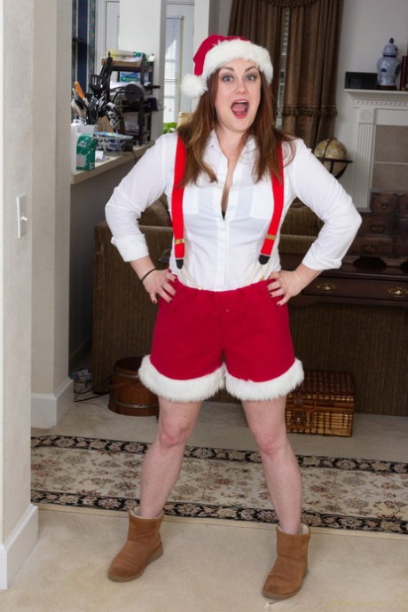 Annatasia Holland strips her Xmas outfit & shows her huge tits & hairy crotch