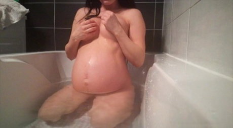 Pregnant teen Lexi Dona fingers her horny pussy while taking a bath