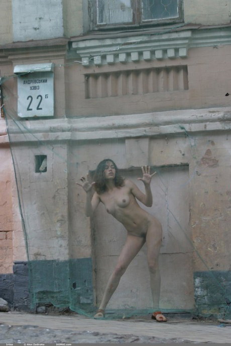 Nice teen poses totally naked on scrap metal before wading into the water