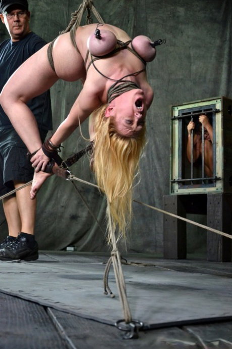 Female sex slaves are masturbated against their will in a dungeon