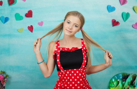 Adorable young girl Flower tugs on pigtails before getting naked in OTK socks