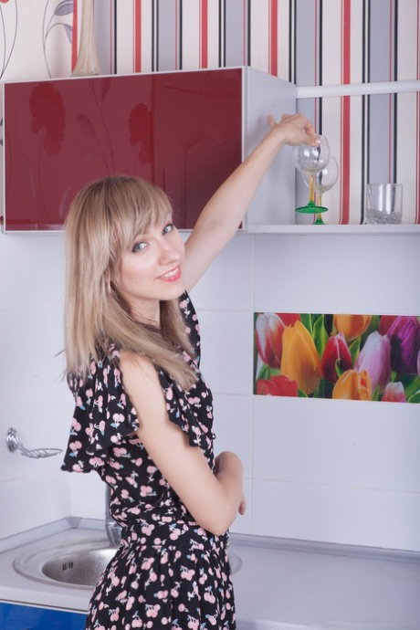 Cute housewife Yuliya undressing in the kitchen and showing her furry crotch