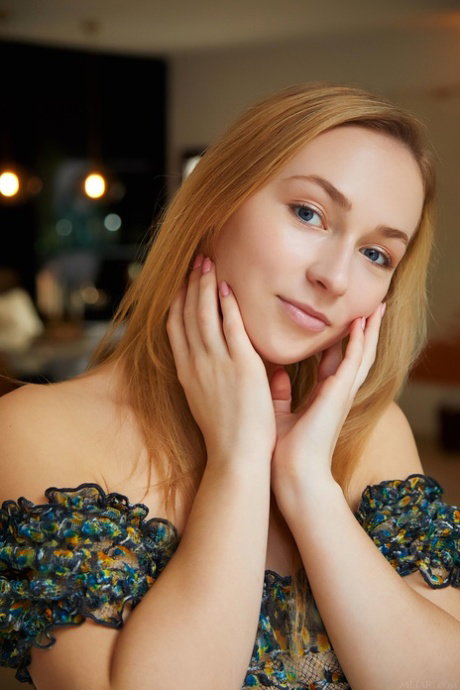 Young blonde Jenny Wild takes off her dress before removing heels from feet