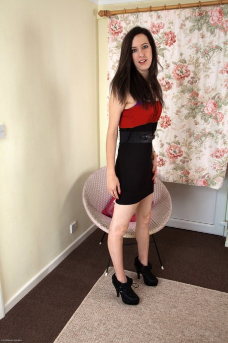 Dark-haired teen with red nails flaunts her furry bush in the nude