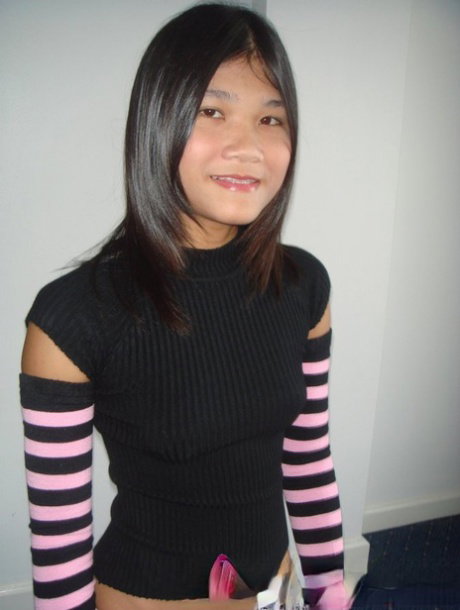 Young looking Filipina girl gets naked while wearing striped arm and leg socks