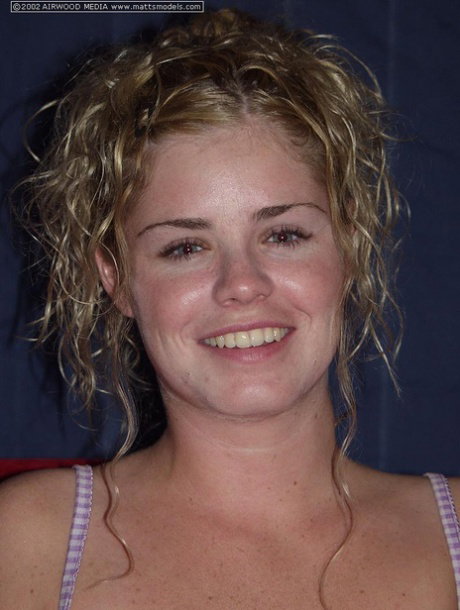 Amateur girl Rikki sports curly blonde hair while stroking her naked pussy