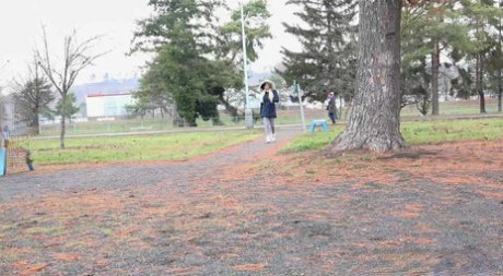 Blonde girl Victoria Pure pulls down her leggings to pee against a public tree