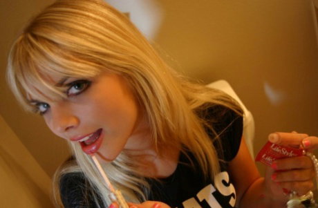 Cute blonde chick Jana Jordan strips to her underwear in the bathroom