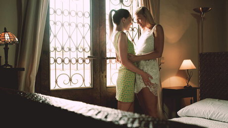 Young lesbians go barefoot while engaging in sex acts on top of a bed