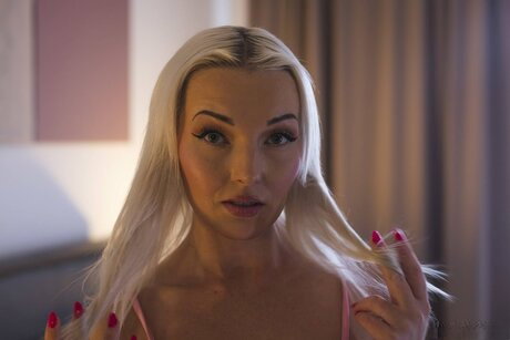 Platinum blonde teen Lovita Fate gets naked on a bed in a thong