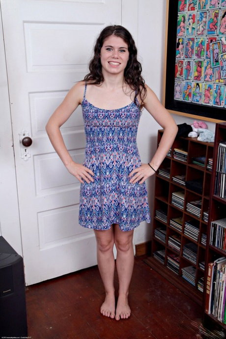 Sweet teen Lexy Lotus strips to black underwear in a room filled with records