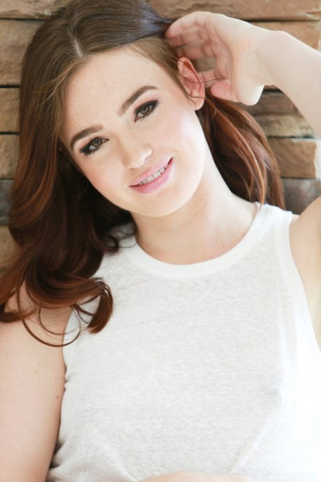 Girl next door type Jodi Taylor uncovers her A-cup breasts as she disrobes