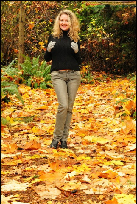 Mature woman Tasty Trixie exposes tits and panties amid fallen leaves