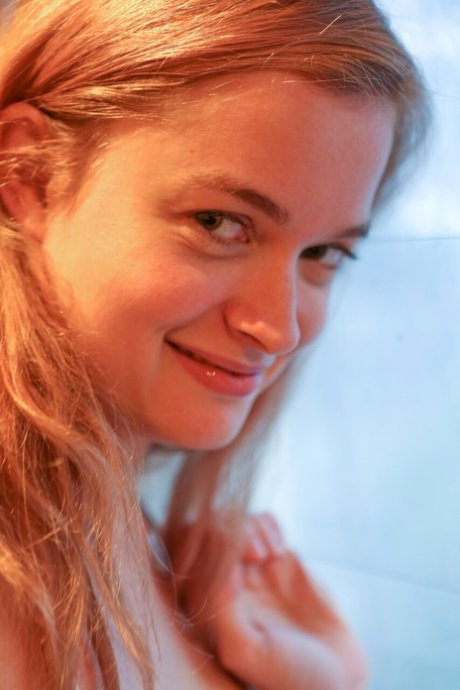 German girl with a pretty face Laney gets naked to play with her bush