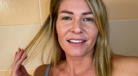 Blonde chick Claudia Macc takes a piss while masturbating in the bathtub