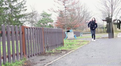 Caucasian girl Katy Sky ducks behind a picket fence for a badly needed pee