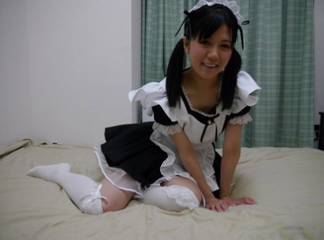 Japanese maid Mai Araki has sex on a bed in her uniform