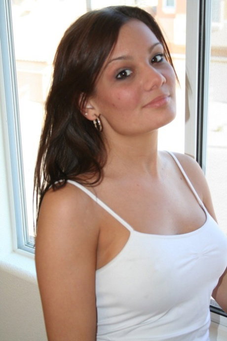 Smoking hot teen Katie strips by the window and exposes her big boobs