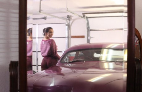 Cute MILF Holly Michaels gets naked for nude posing inside vintage automobile