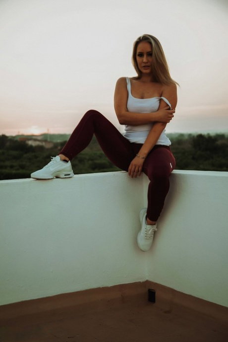 Blonde chick Candice Collyer doffs black leggings to get naked on a balcony