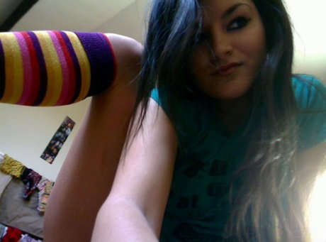 Cute brunette Gina teases in her bedroom while wearing striped socks
