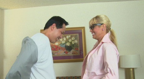 Blonde cougar Mikki Lynn goes topless while jerking a dick in her glasses