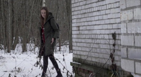 Caucasian girl Valya takes a piss next to a building during the winter